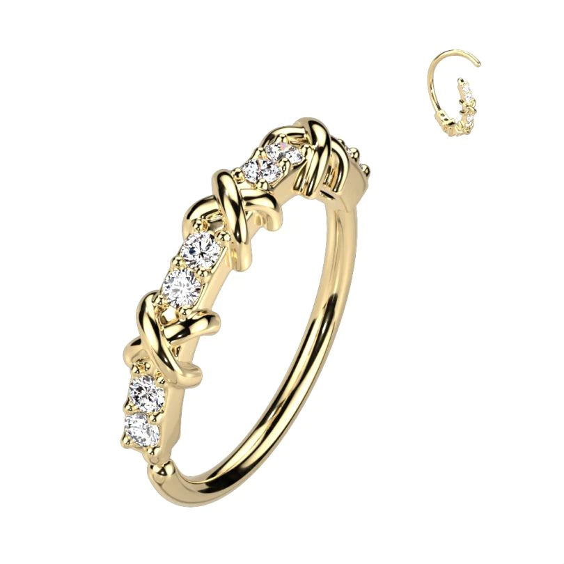 Twist ring with cross design and row of stones