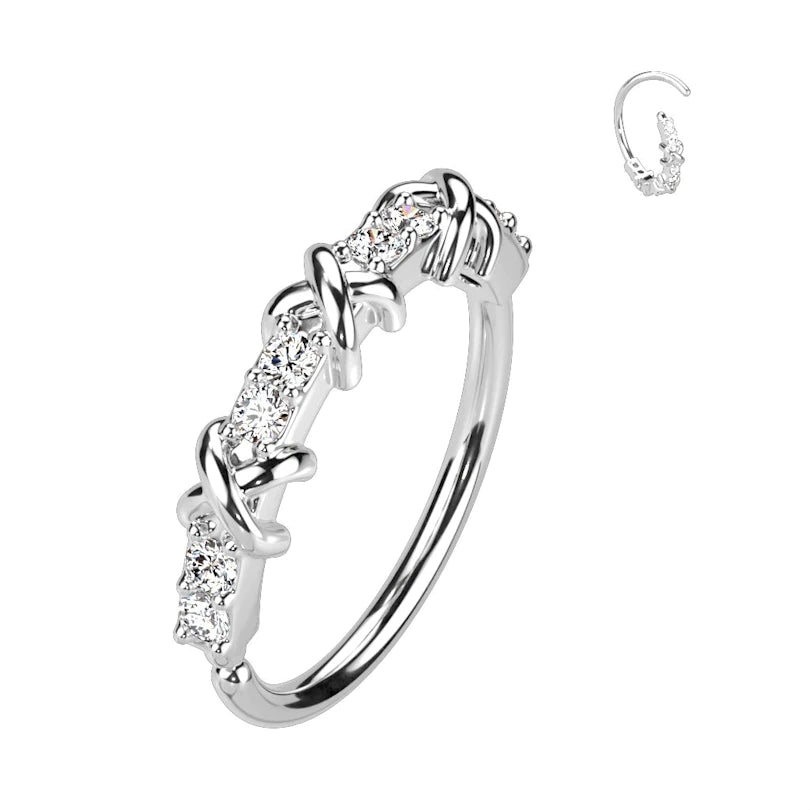 Twist ring with cross design and row of stones