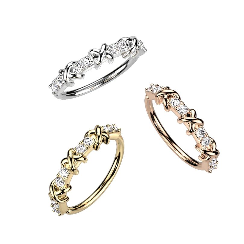 Twist ring with cross design and row of stones